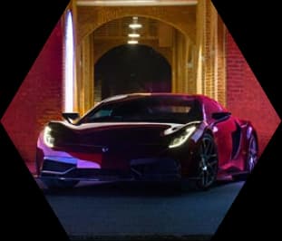 A sports car driving through a brightly lit tunnel